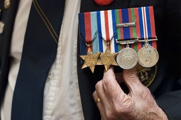senior citizen wearing naval war medals