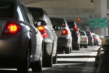 A long line of idling cars on a Toronto street