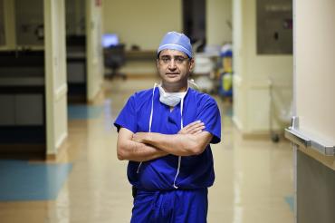 Shaf Keshavjee in a hospital hallway in surgical scrubs