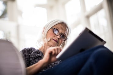 an older woman using an ipad