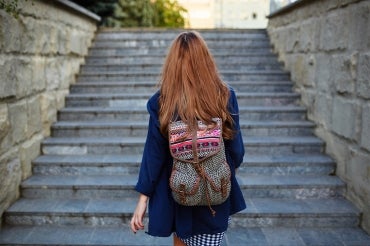 young woman going up a set of stairs