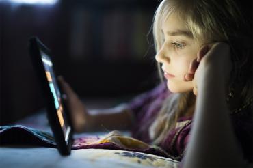 Photo of a teen looking at an iPad