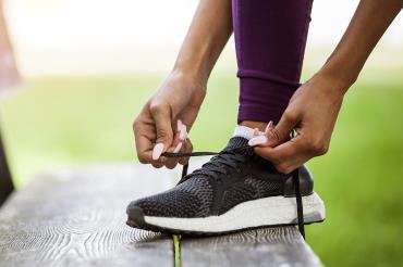 woman ties a running shoe