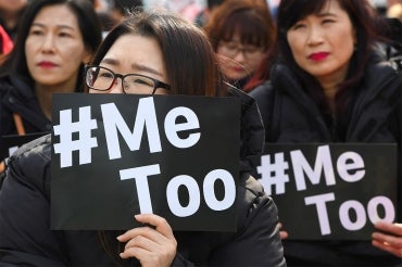 South Korean demonstrators hold banners during a rally to mark International Women's Day