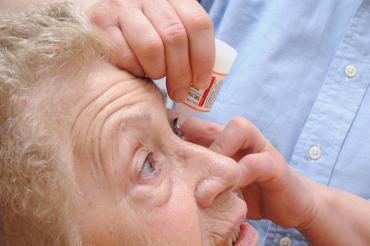 Photo of a glaucoma patient receiving eye drops