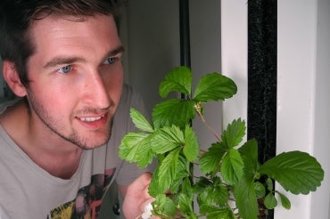 photo of alumnus with plant