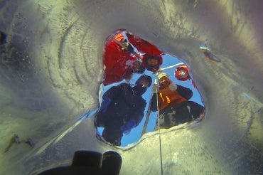photo of camera being lowered below ice