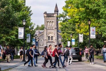 photo of students crossing road in front of University College