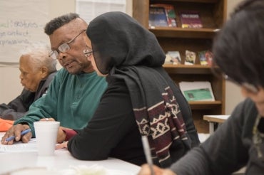 Instructor and students at a writing workshop