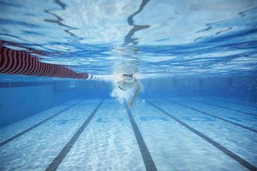 An underwater view of a swimmer in the pool at the University of Toronto's Athletic Centre