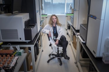 Lisa Strug sits on a chair in a hallway