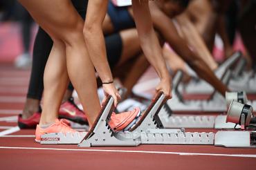 Runners line up in the starting block at the Tokyo Games