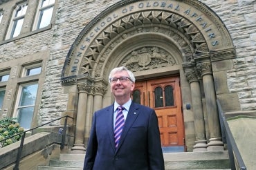Stephen Toope standing in front of the Munk building