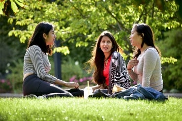 Students sitting on the lawn and talking