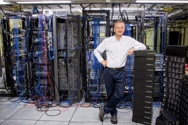 Geoffrey hinton stands in a server room
