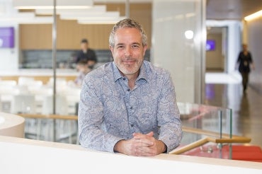 portrait of Brendan Frey seated at a desk