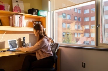 a girl studying at a desk in a residence at UTM