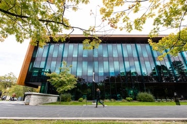 A student walks by a building on the U of T Mississauga campus
