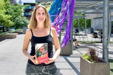 Portrait of Andrea Benoit holding her book Viva Mac