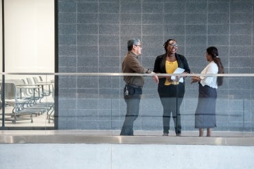 three staff members at UTM from different cultural backgrounds have a discussion