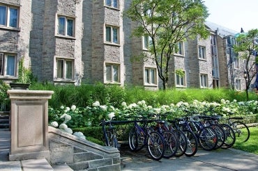 Photos of bicycles locked up outside of a building on campus