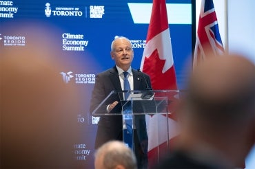 Meric Gertler at the podium at the Toronto Region Board of Trade Climate Summit in Toronto