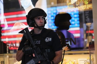 Heavily armed policeman stands on guard in Times Square