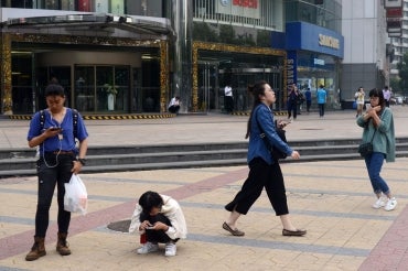 Women looking at their mobile phones