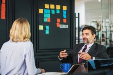 Photo of two workers talking