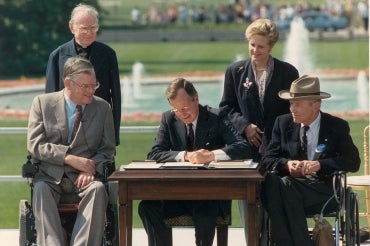 George H.W. Bush signing the Americans with Disabilities Act 