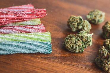 Photo of cannabis candy and cannabis buds sitting on a table