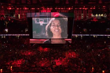 an image of hannah flores is shown on the big screen at scotiabank centre during the raptors home opener