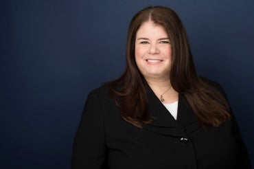 Portrait of Linda Hills against blue background