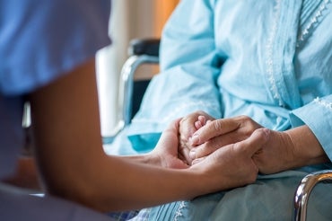 Picture illustration of nurse holding patient's hands