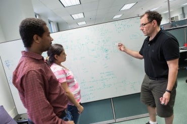 Jonathan Rose with two students