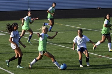 High school students playing soccer