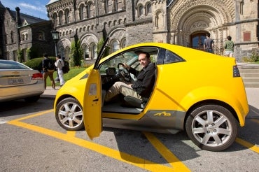 Photo of Olivier Trescases sitting in an electric car