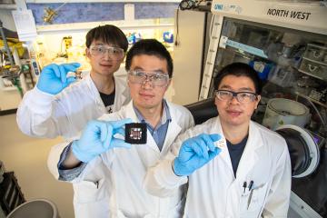 Leiwei Zeng, Zaiwei Wang and Hao Chen show off samples of triple-junction perovskite solar cells