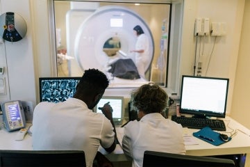 MRI technicians observe an MRI scan