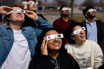 UTSC students wearing solar eclipse glasses