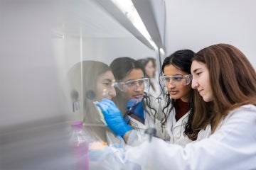 Two students work under a fume hood at a U of T lab