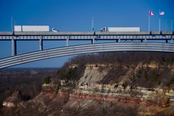 two trucks crossing in opposite directions at the queenston-lewiston bridge near Niagara Falls connecting the USA and Canada