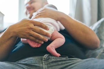 Father holding a newborn infant