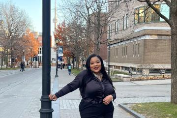 Lashae watson stands on King's College Road with the CN Tower in the background