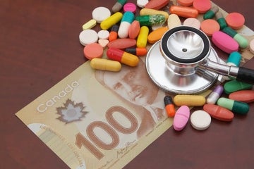 Photo illustration that includes pharmaceuticals, money and a physician's stethoscope