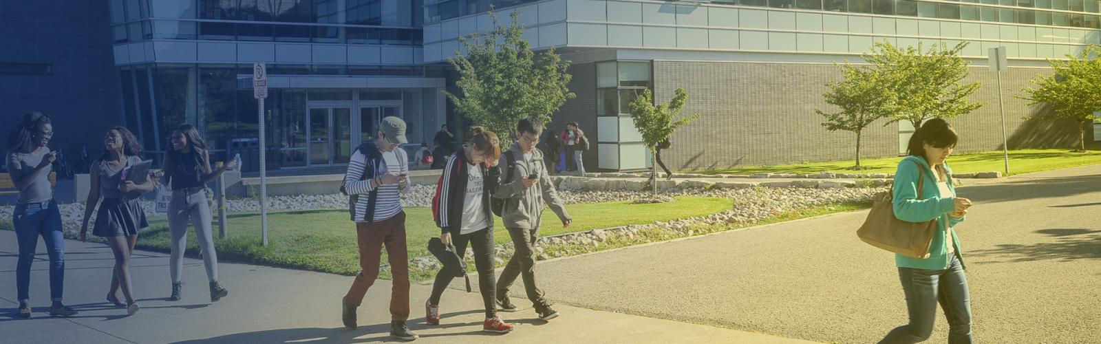 Students walking outside a UTM building.