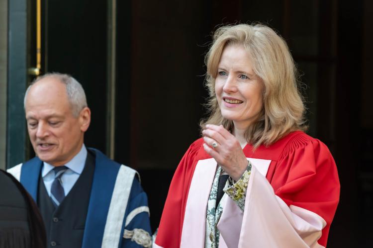 Claire Kennedy exists Simcoe Hall on her way to Convocation Hall for her honorary degree ceremony