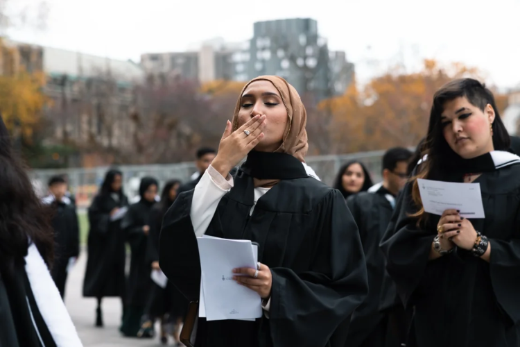 a muslim student from utm blows a kiss before entering convocation hall