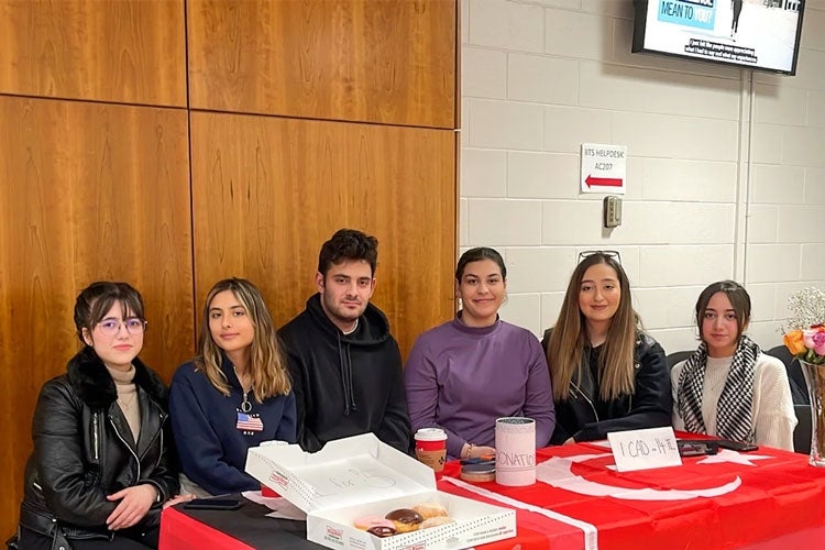 Turkish Students Association members Lilaf Salman, Irem Demirel, Selcuk Maslak, Elif Baran, Yasmin Din and Sedika Salman at their donation table at U of T Scarborough