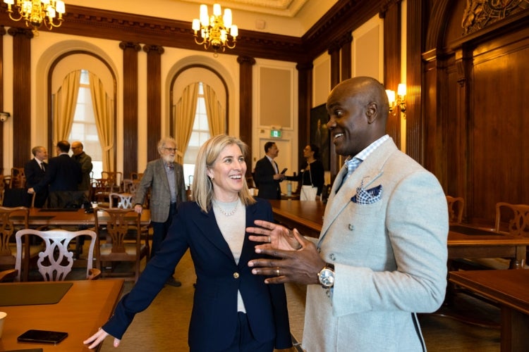 Woodin chats with U of T Chancellor Wes Hall following a meeting of Governing Council on March 26, 2025.